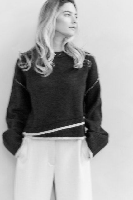 Knitted sweater with contrasting lines