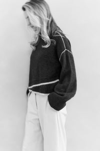 Knitted sweater with contrasting lines
