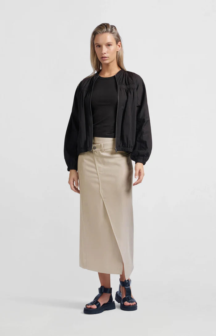 A women's lightweight bomber jacket in a soft beige color with a relaxed, slightly oversized fit. It features a round neckline, a full-length front zipper, and gathered detailing along the chest for a subtle textured effect. The long sleeves are voluminous and taper into elasticated cuffs, while the hem also has an elastic finish for a comfortable and slightly cropped silhouette.
