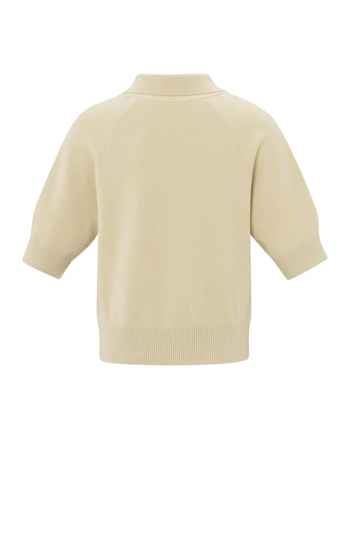 his is a women's short-sleeve zip-up cardigan in a soft, warm beige color. It is made from a finely knitted fabric with a smooth texture and a structured yet comfortable fit. The cardigan features a classic folded collar that sits neatly around the neckline, leading down to a silver-toned full-length zipper at the front, allowing it to be worn open or closed.

The sleeves are elbow-length with a slightly loose fit, finished with ribbed cuffs for a subtle contrast in texture. The hem is also ribbed, giving t